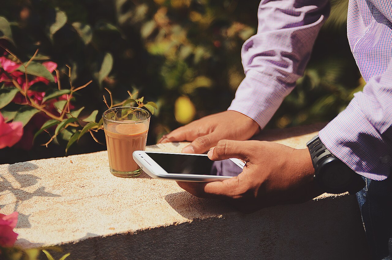 Hands holding a phone while sending a message