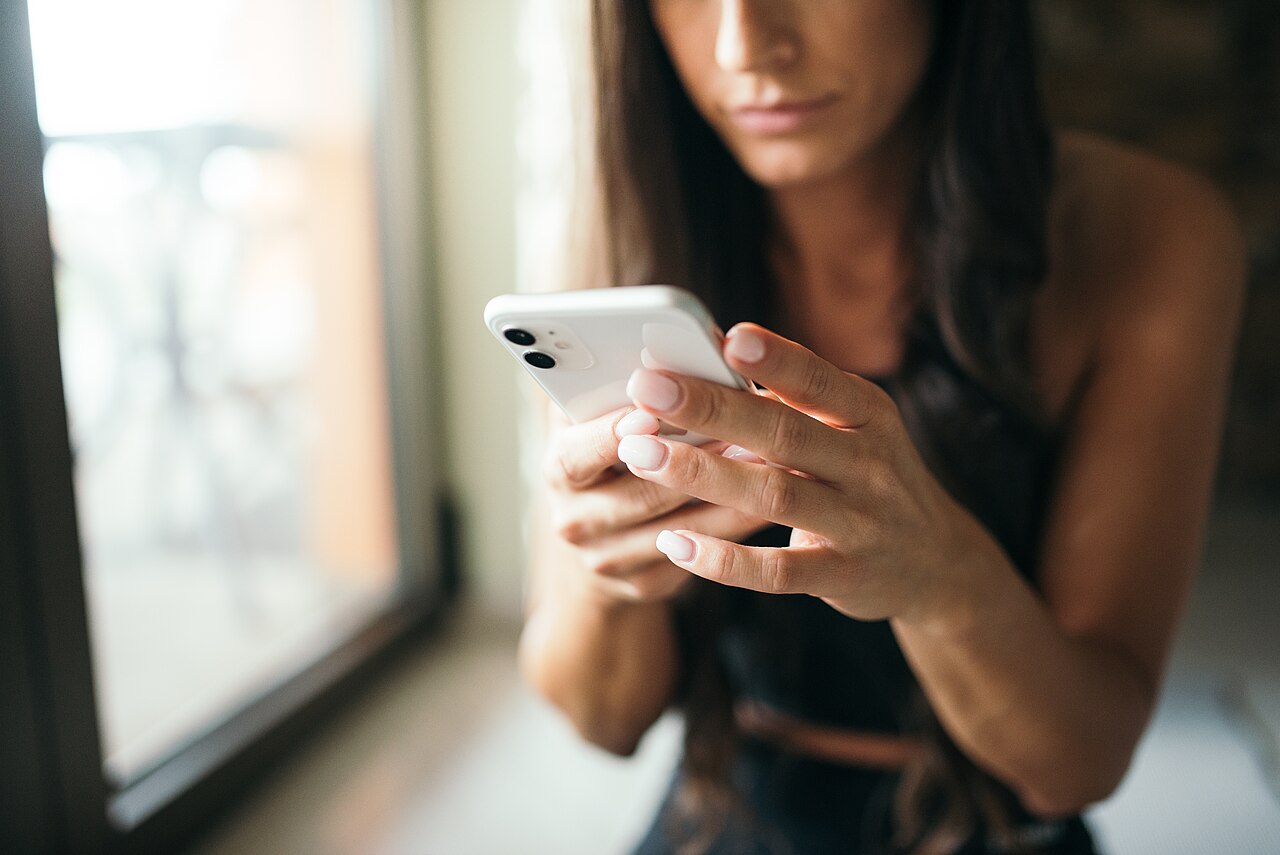 A woman reading something on her phone