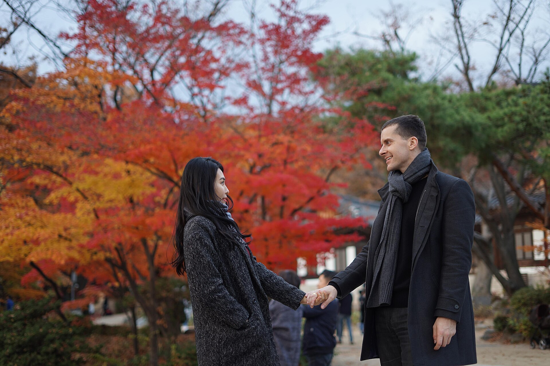 A couple holding hands outdoors