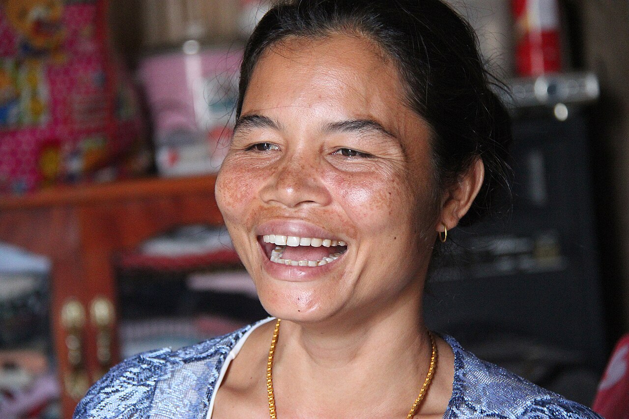 A woman laughing indoors