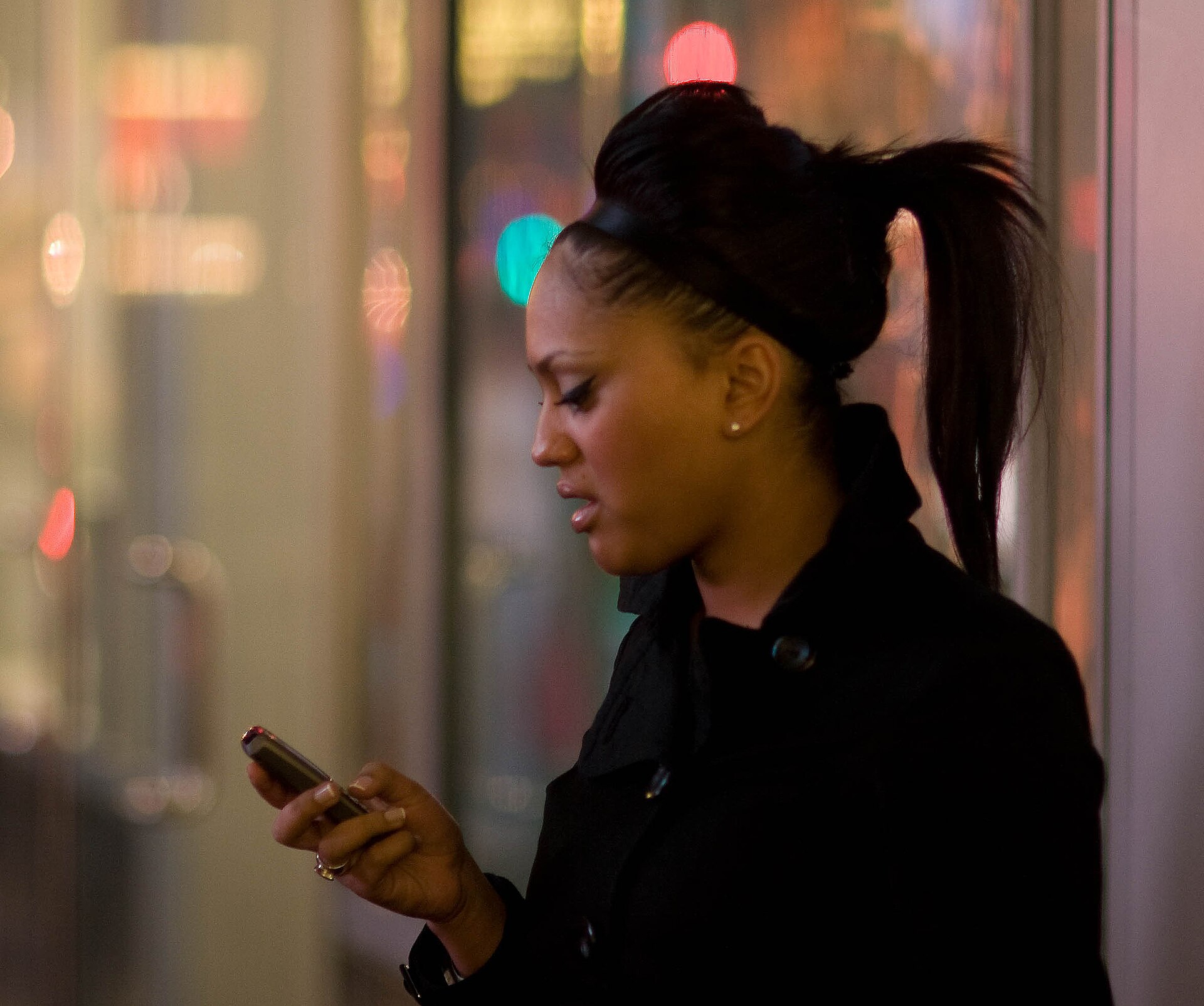 A woman reading a message on her phone