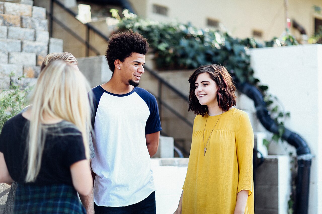 Three young people talking outdoors