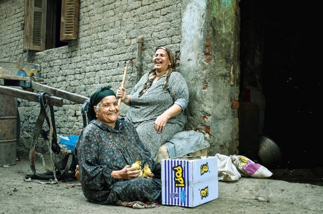 Two friends chatting and laughing together